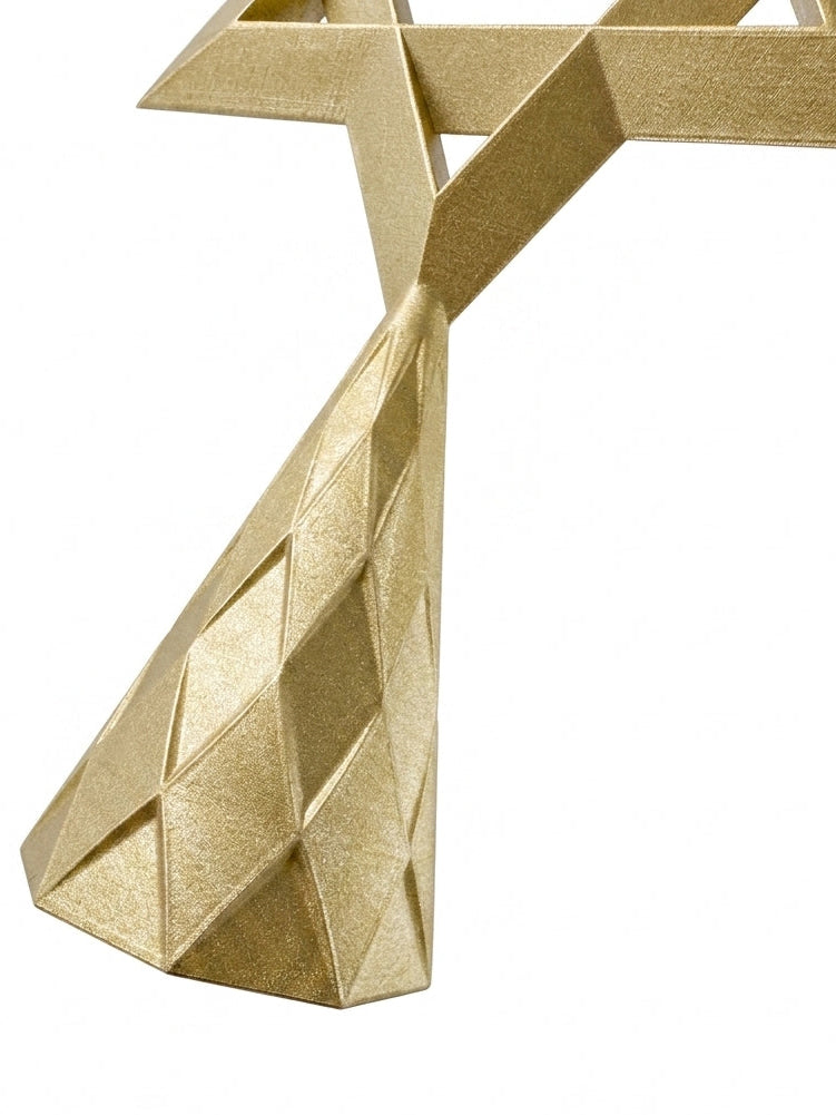 A close-up of the gold geometric base of the Star of David Tree Topper with faceted diamond-patterned panels, shown against a plain white background.